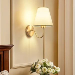 Elegant guldfärgad vägglampa med tygskärm – Klassisk modern belysningsaccent